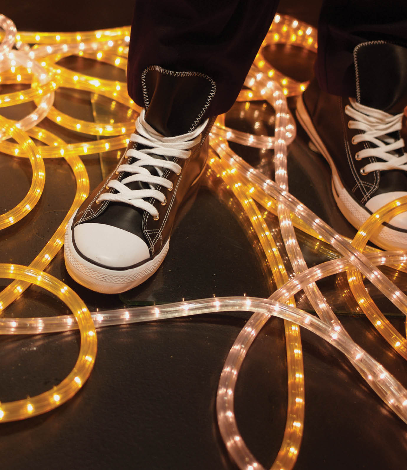 Sneaker displayed in window, yellow neon light